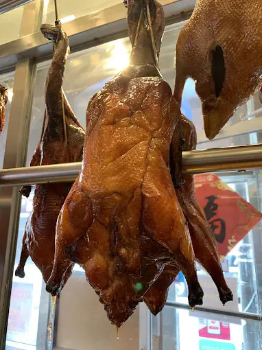 Roasted Peking ducks hanging in a display window at Canto House, a Chinese restaurant in Philadelphia